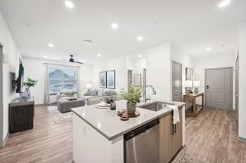 a kitchen with a large island and a living room at The Garrison Luxury Apartment Homes, Fountain, 80817